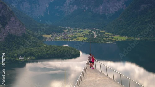 TRACKING ZOOM OUT, Dramatic viewpoint rest stop for a sporty running couple