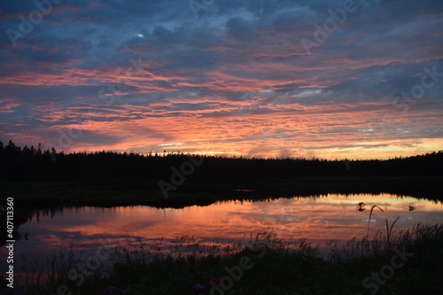 A beautiful sunset reflects in a pond outside of Acadia National Park in Maine.