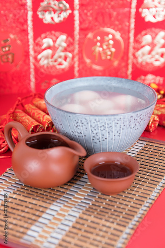 A bowl of dumplings and tea on the festive background photo