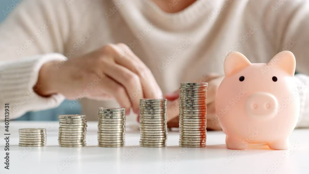 Closeup man hand stacking coin for save money concept