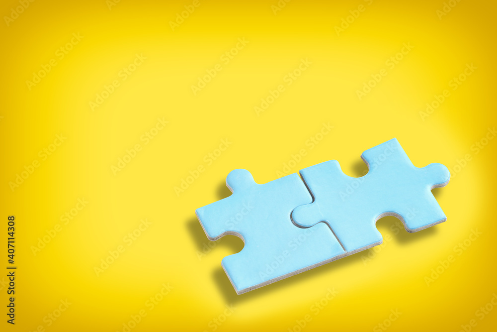 Fototapeta premium Blue puzzle jigsaw with shadow on yellow background. Business partnership concept and together solve problem idea