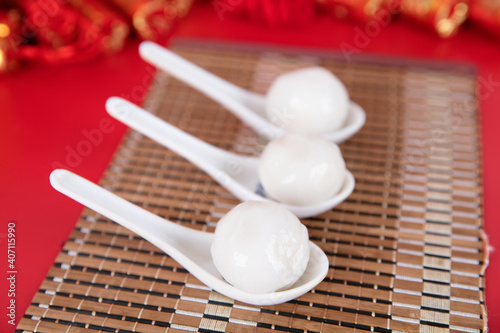 Spoon with dumplings on the red background