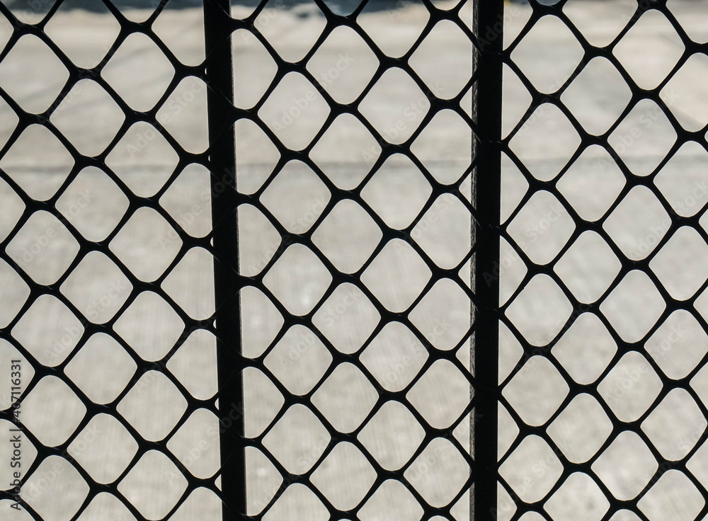 Fototapeta premium steel fence with thick grid net for security