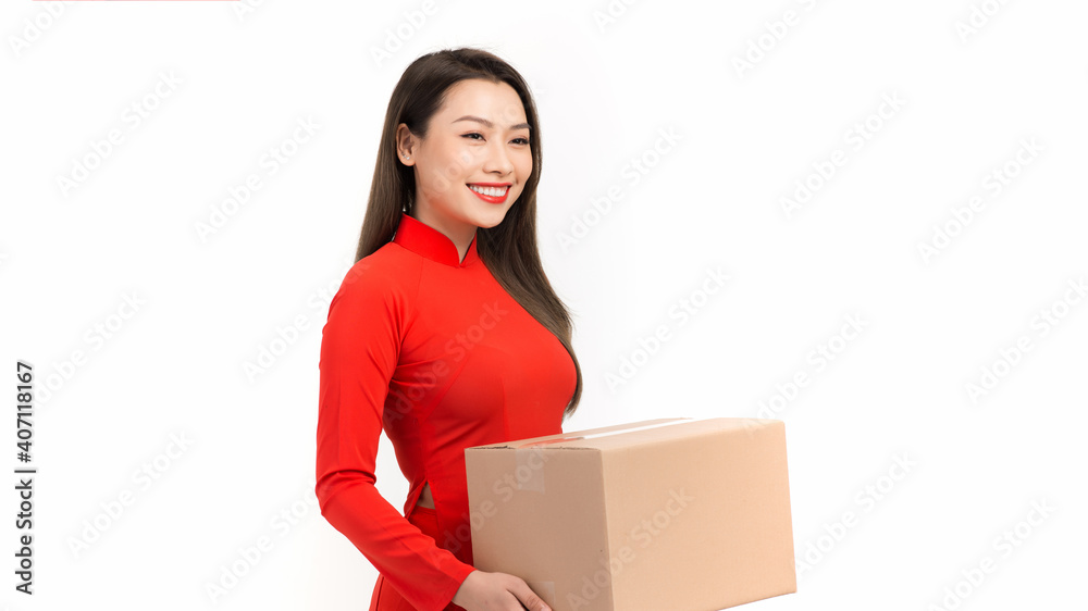 Beautiful smiling young woman holding present wrapped in golden wrapping paper wish young a have a happy new year Beautiful smiling young woman holding present wrapped in golden wrapping paper wish young a have a happy new year