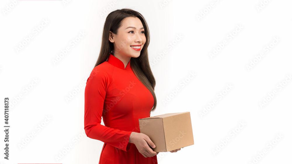 Beautiful smiling young woman holding present wrapped in golden wrapping paper wish young a have a happy new year Beautiful smiling young woman holding present wrapped in golden wrapping paper wish young a have a happy new year