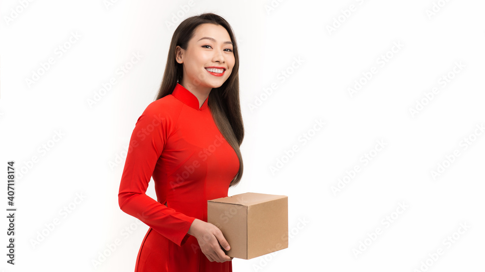 young woman holding red gift box in concept of happy lunar new year isolated on a white background young woman holding red gift box in concept of happy lunar new year isolated on a white background