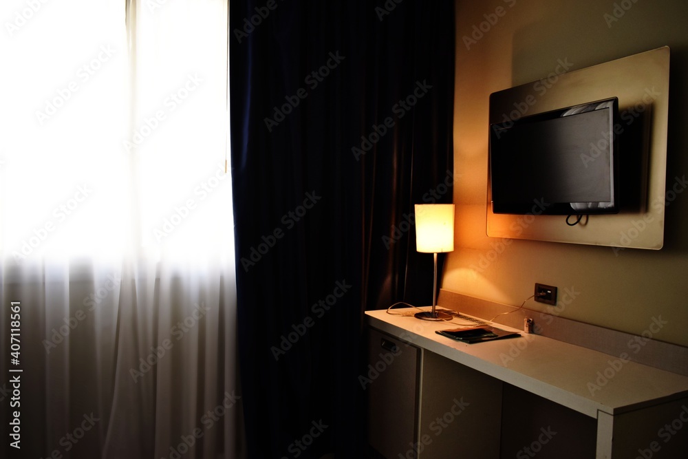 a fashioned themed room illuminated with a table lamp and sunlight through the white curtain a fashioned themed room illuminated with a table lamp and sunlight through the white curtain