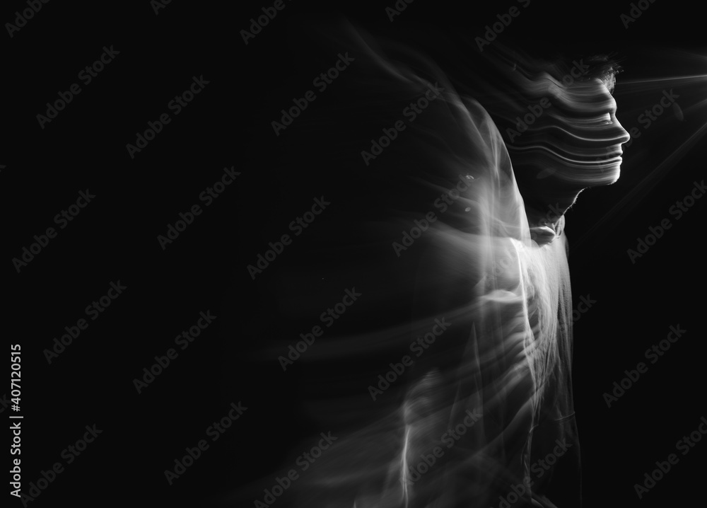 Facial face of a man in the dark. Art photography. Black-white art picture with a man. Portrait of man with blurred motion