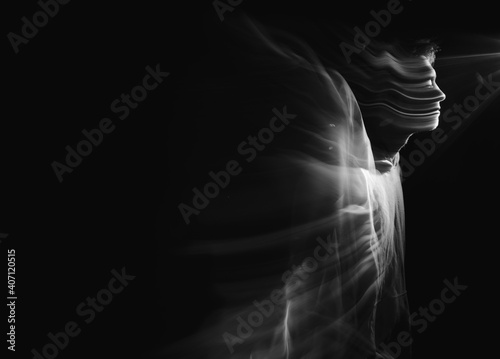 Facial face of a man in the dark. Art photography. Black-white art picture with a man. Portrait of man with blurred motion