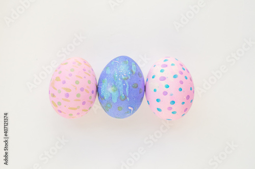 Set of colorful hand-painted Easter eggs. Bright children's drawings on Easter eggs top view on a white background. Happy Easter holiday and fun for children