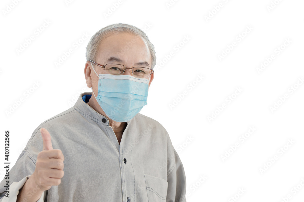 Asian senior elder man with face mask hand showing thumbs up isolated on white background with clipping path Asian senior elder man with face mask hand showing thumbs up isolated on white background with clipping path