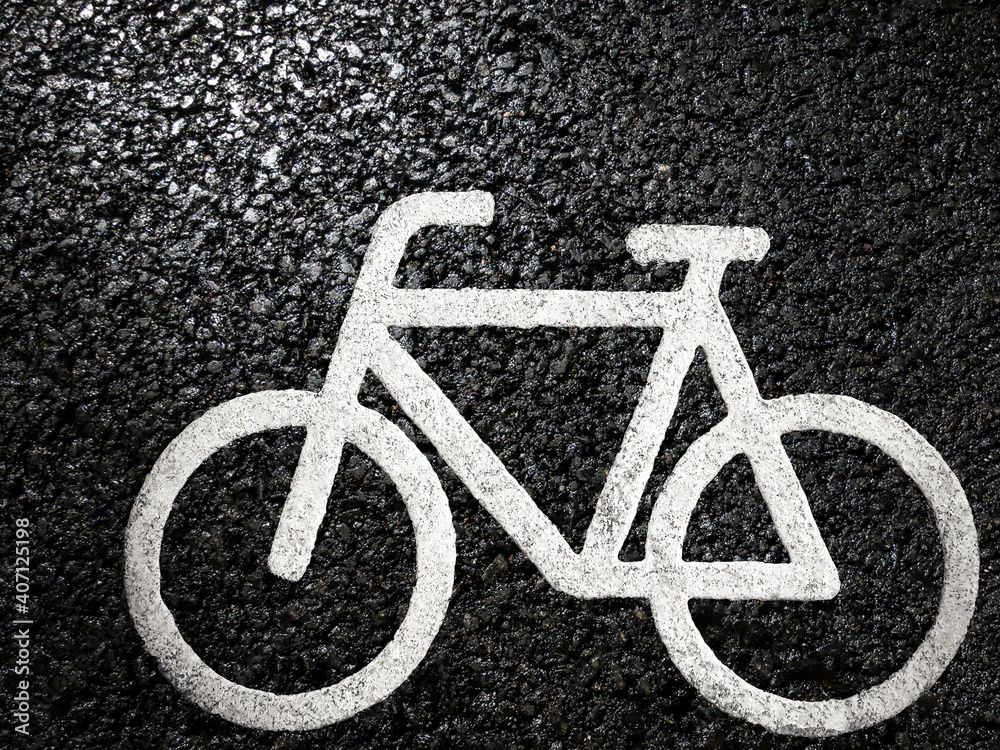 Road sign indicating a cycle path on asphalt texture; bicycle ride in outdoors Road sign indicating a cycle path on asphalt texture; bicycle ride in outdoors