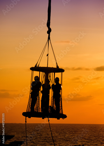 silhouette of a oil platform crew