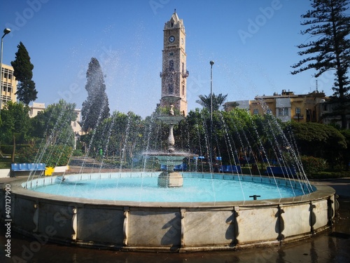 fountain in the park with ottoman clock tower 