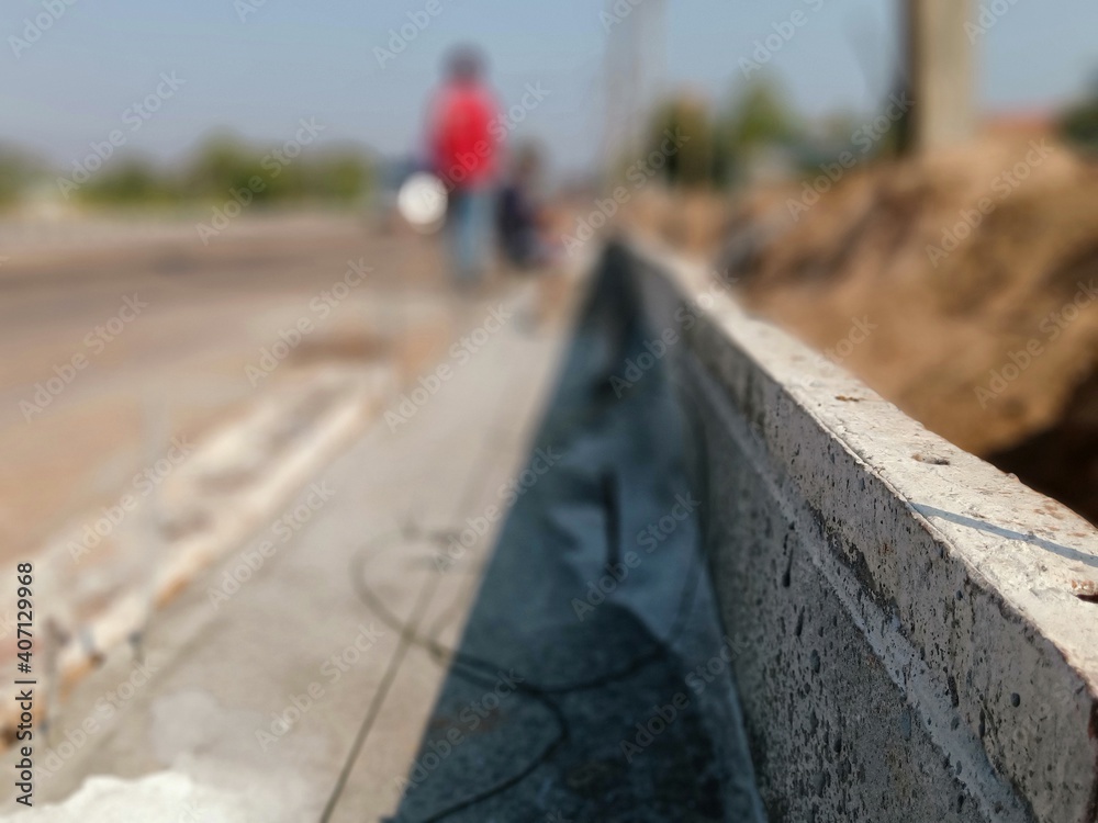 Blurred images of concrete road construction and curb