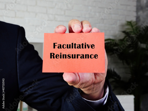  Financial concept meaning Facultative Reinsurance with sign on the sheet. photo