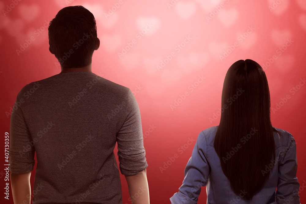 Rear view of Asian couple standing and holding hands each other