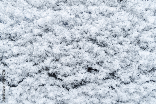Background of fresh white snow. Winter snowflakes texture. Snow white texture winter background. Icy surface pattern. Shiny snow with bokeh
