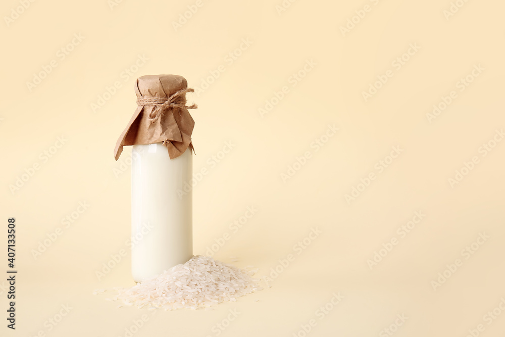 Fototapeta premium Bottle of rice milk on color background