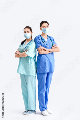 Portrait of female doctors on light background