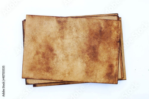 Pile of old brown paper grunge background. Abstract liquid coffee color texture.
