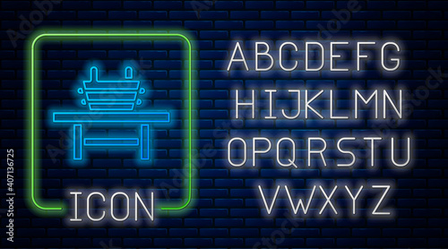 Glowing neon Sauna bench with bucket icon isolated on brick wall background. Neon light alphabet. Vector.