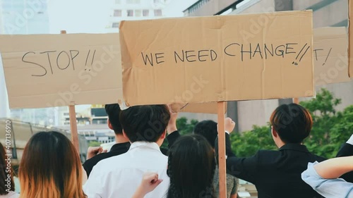 Group of asian protester against government corruption. Raise banner to show purpose from people in the city.