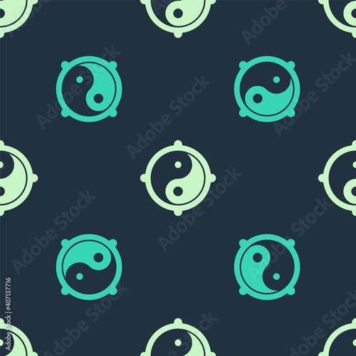 Green and beige Yin Yang symbol of harmony and balance icon isolated seamless pattern on blue background. Vector.
