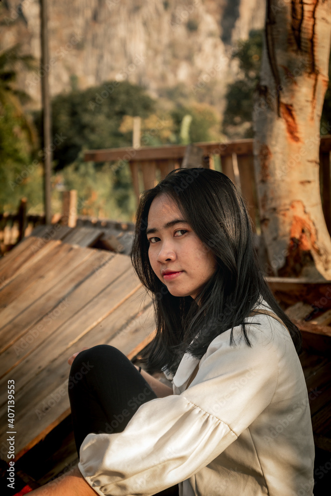Portrait girl teen asian white dress is sitting