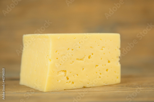 a block of cheese on the wood table