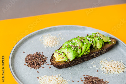 Ingredients for healthy avocado toast. Sesame flax seeds. Vegan keto diet. Healthy eating. Minimalistic concept in isometric style in trendy colors. photo