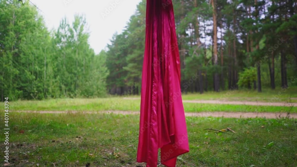 Woman hanging in a hammock for fly yoga in the park Woman hanging in a hammock for fly yoga in the park