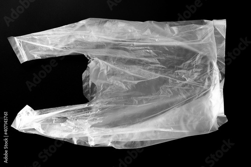 White plastic bag isolated on black. Empty crumpled plastic bag isolated on a black background. Used plastic bag is intended for recycling.