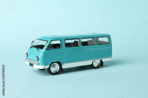 Toy bus on blue background, close up and space for text