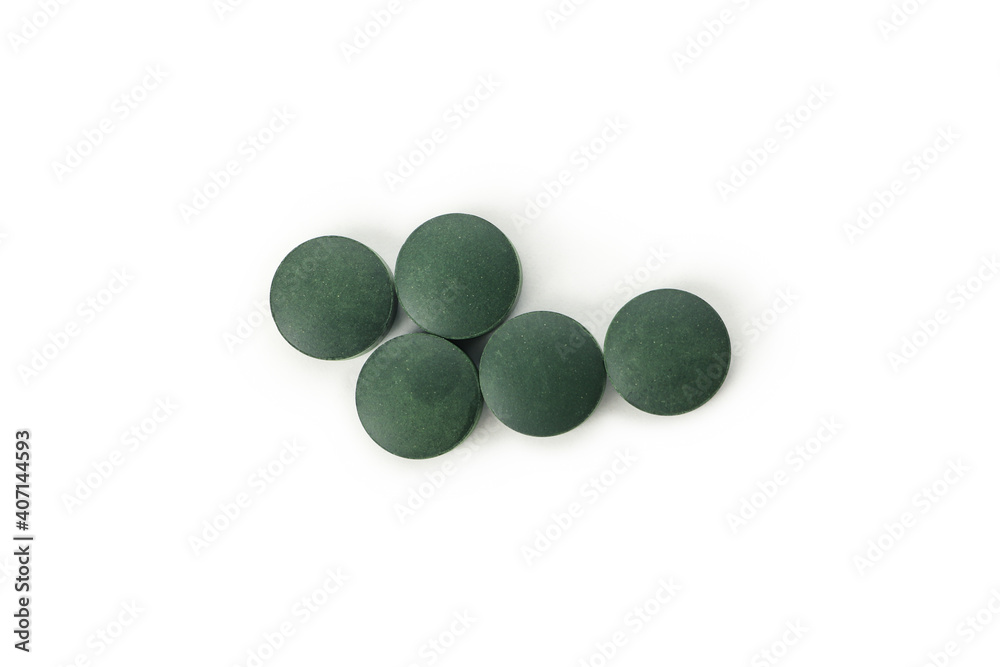 Spirulina in pills isolated on white background Spirulina in pills isolated on white background