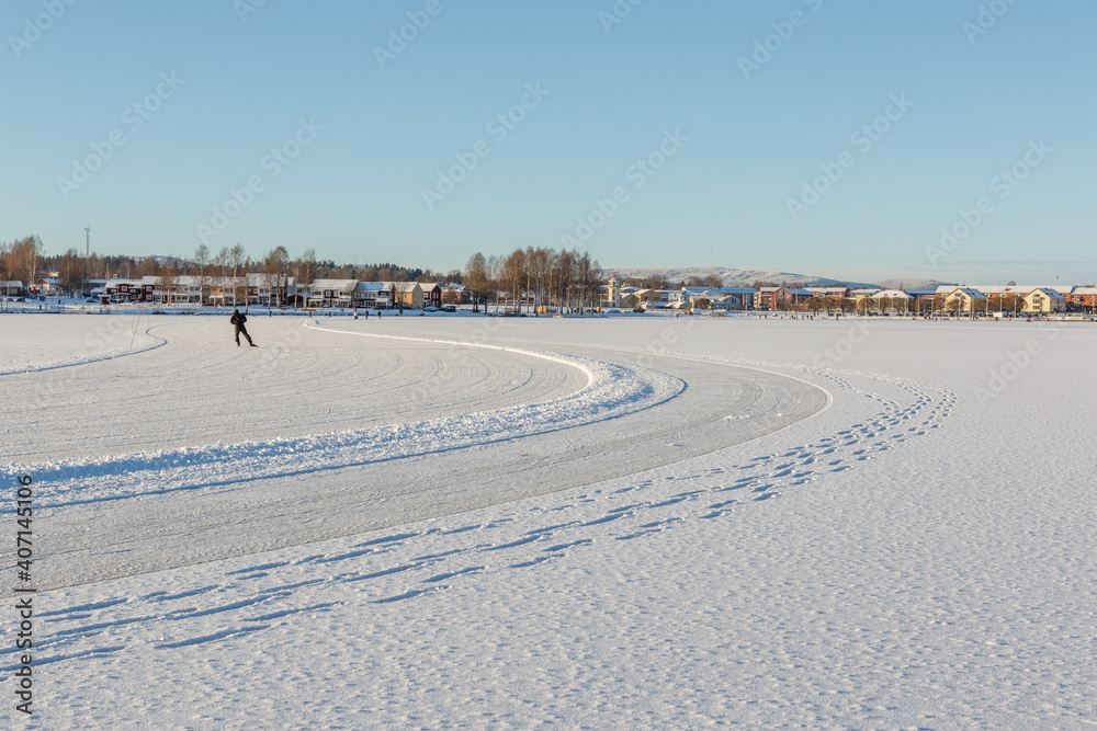 one person skating on a frozen lake