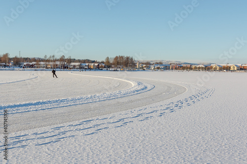 one person skating on a frozen lake