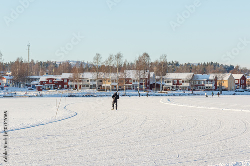one person skating on a frozen lake