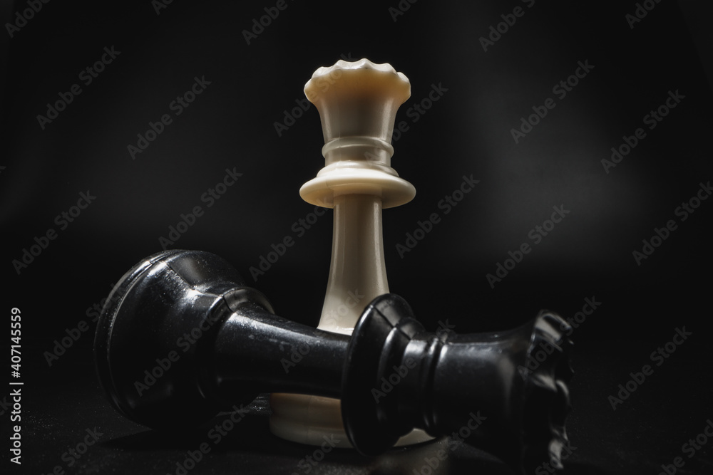 Chess game with chess pieces against black background Chess game with chess pieces against black background