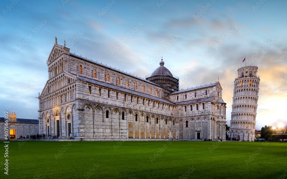 Panorama of Pisa Cathedral (Duomo di Pisa) with Leaning Tower (Torre di Pisa) and Baptistery of St. John (Battistero di Pisa) in Tuscany, Italy at sunset. One of the main landmark in Italy.