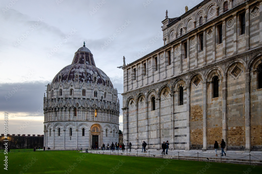 Panorama of Pisa Cathedral (Duomo di Pisa) with Leaning Tower (Torre di Pisa) and Baptistery of St. John (Battistero di Pisa) in Tuscany, Italy at sunset. One of the main landmark in Italy.