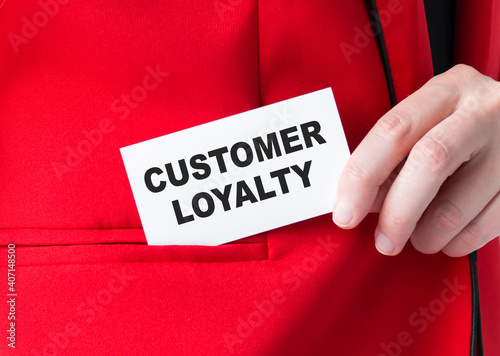 Customer loyalty card in businessman hands, which he puts into the korman of the red jacket