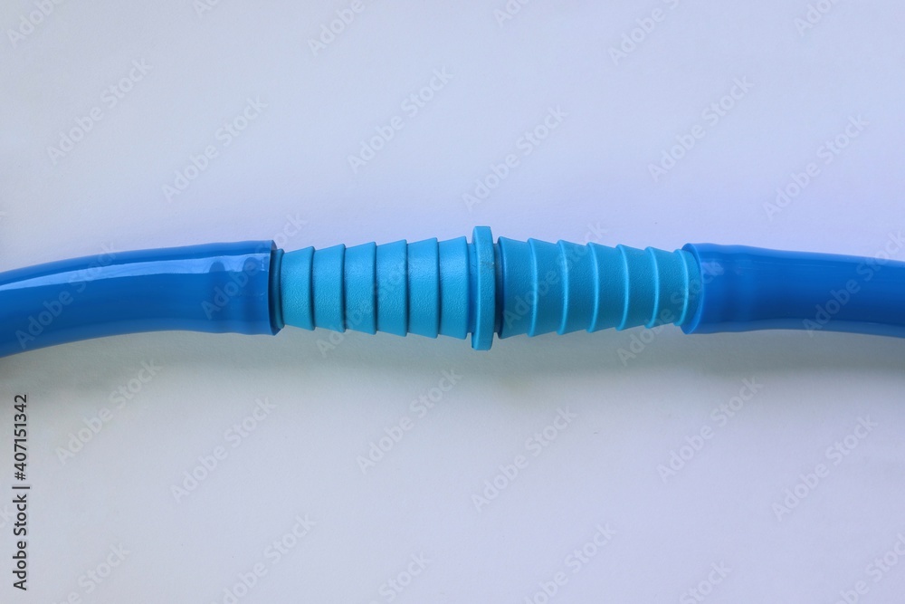 Blue PVC joints connected with blue plastic hose isolated on white background closeup. Blue PVC joints connected with blue plastic hose isolated on white background closeup.