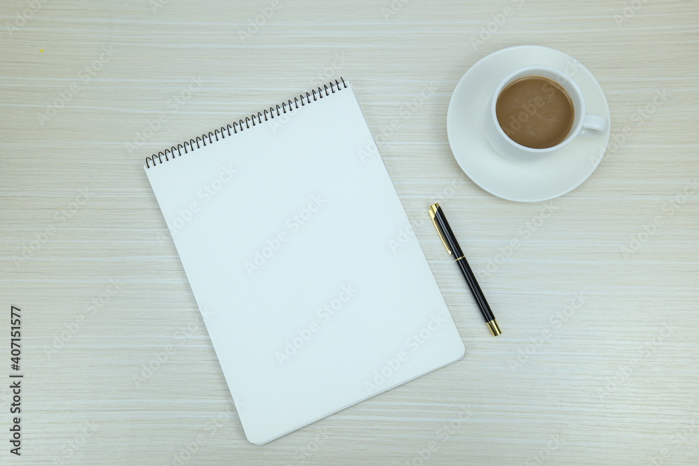 Top view of office workplace. Open blank notebook, pen, and coffee Top view of office workplace. Open blank notebook, pen, and coffee