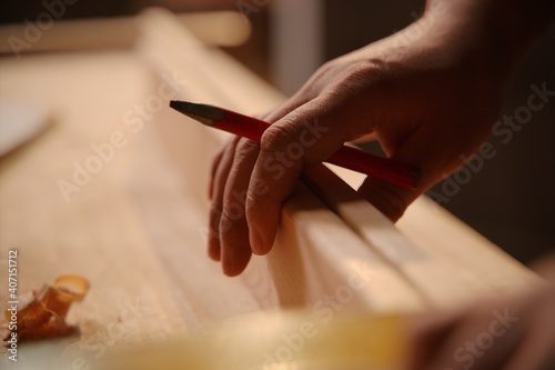 Closeup of carpenter's hand at work, woodwork and furniture making concept