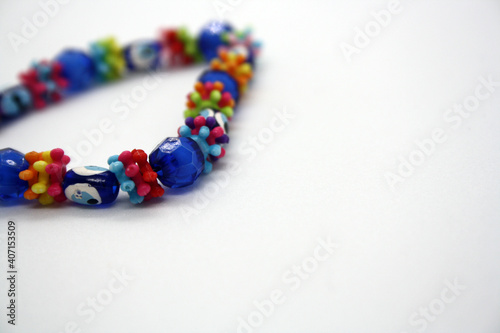 A bracelet made of beads on a white background.