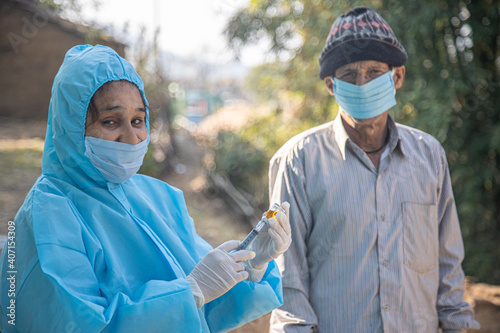 Photography Doctor's hands in surgical gloves preparing COVID-19 vaccine for male patient in