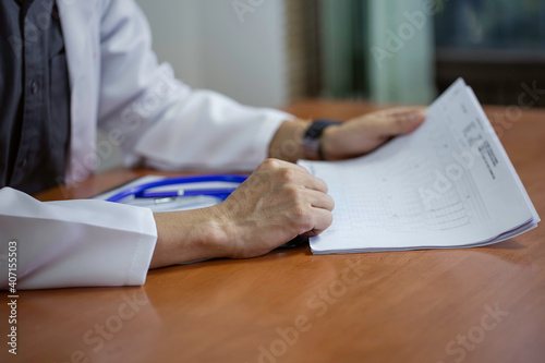 Selective focus of Doctor hand with a prescription consultation in a form. A medical worker in the office ,health concept