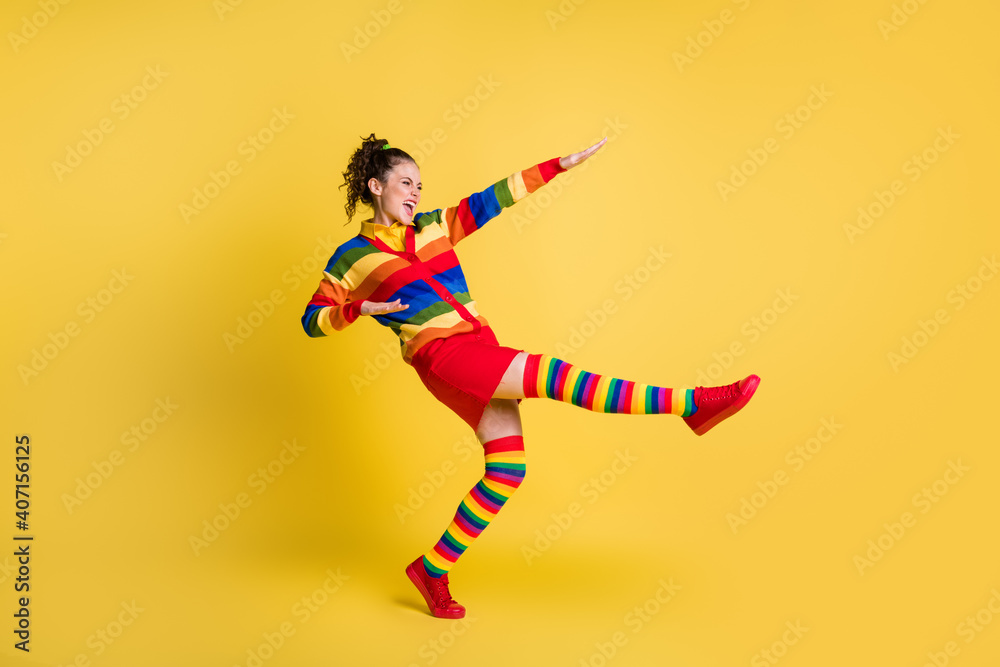 Profile photo of funky lady raise hands leg youth moves wear striped sweater short skirt knee socks shoes isolated yellow color background