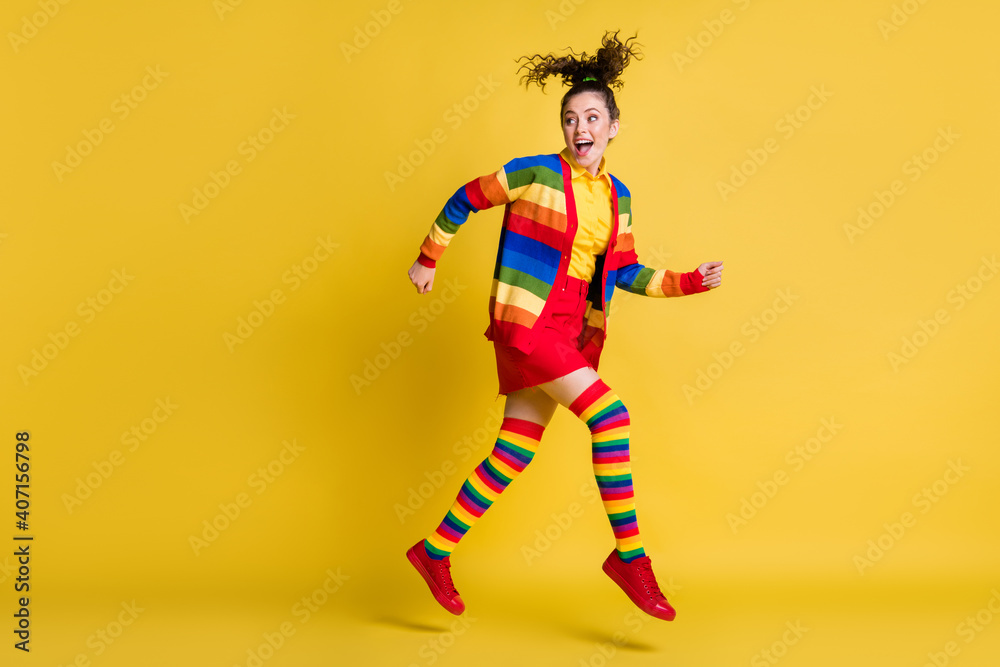Full length body size view of pretty glad cheerful wavy-haired girl jumping running isolated bright yellow color background